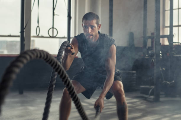 Person doing waves with a battle rope.